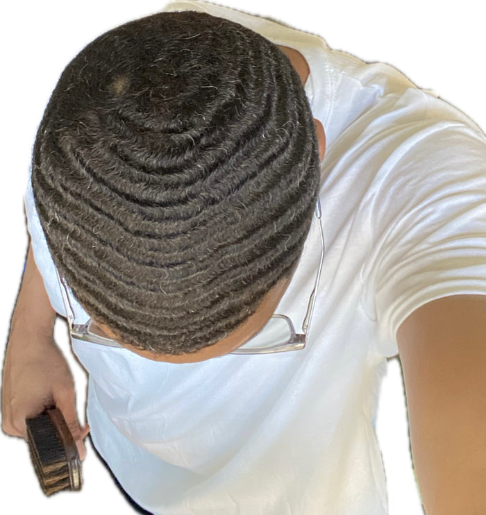 Surefire Youth community member holding a brush and showing his wave pattern